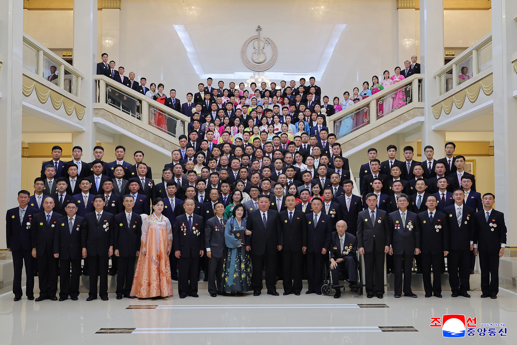 Respected Comrade Kim Jong Un has photos taken with creative workers and artistes of National Symphony Orchestra greeting its 80th founding anniversary